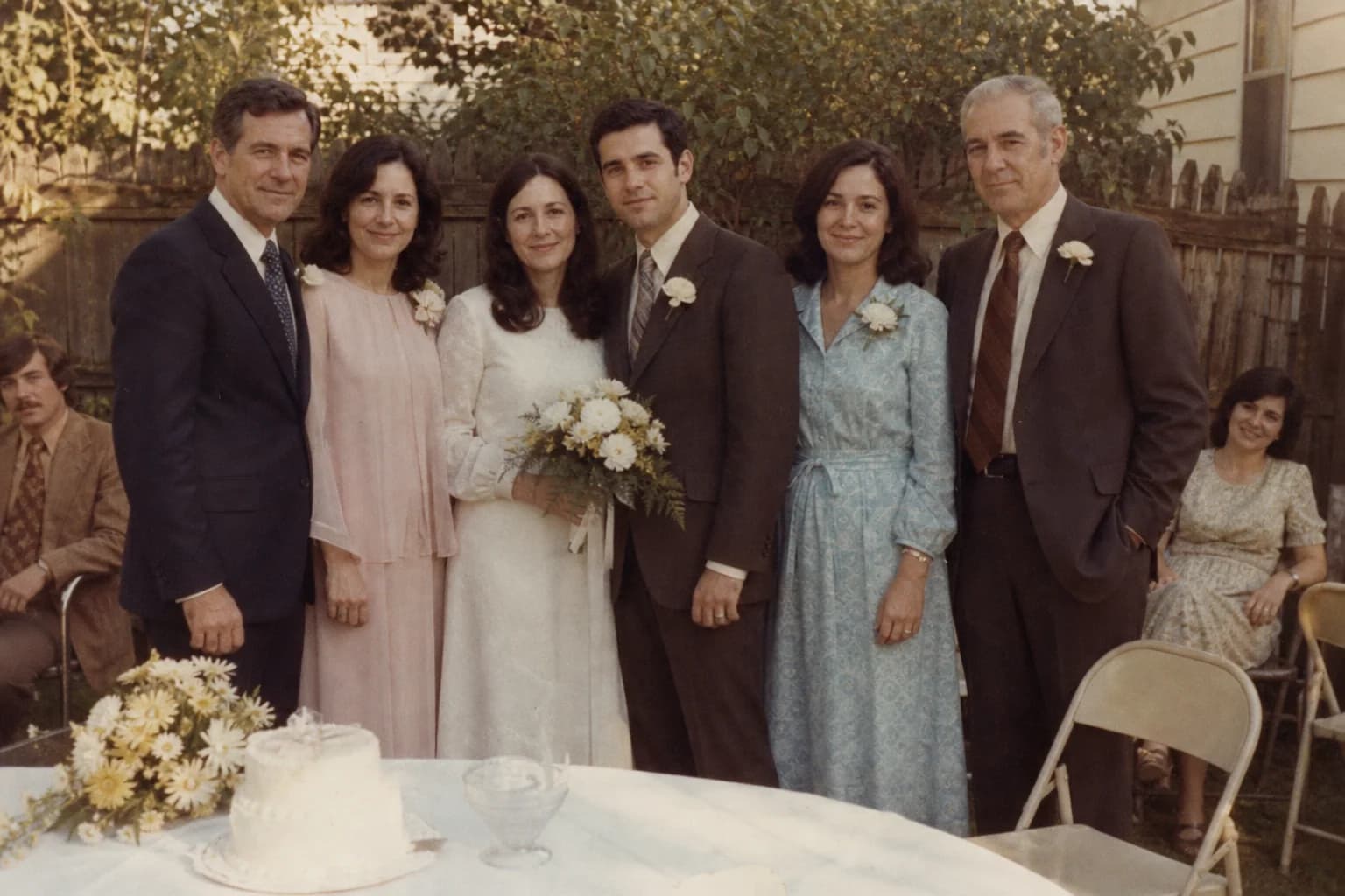 James Bennett and his bride standing with the Bennett family after their backyard wedding in 1973.