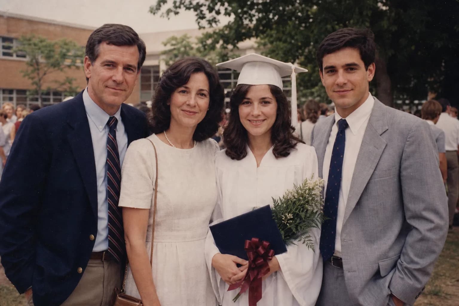 Claire Bennett in her graduation cap and gown with family members in 1988.